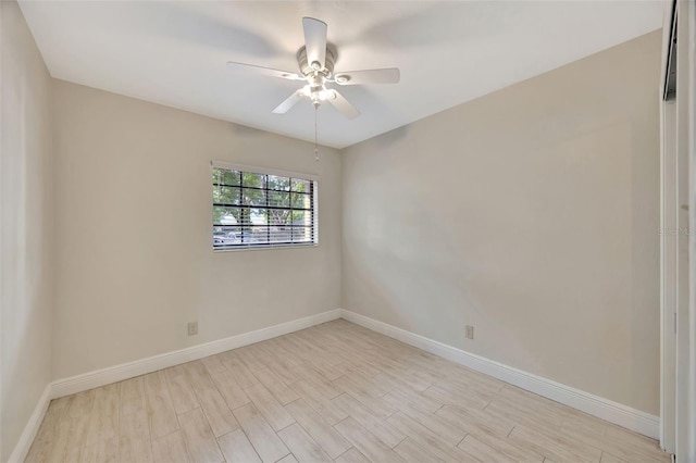 empty room featuring baseboards, a ceiling fan, and light wood-type flooring