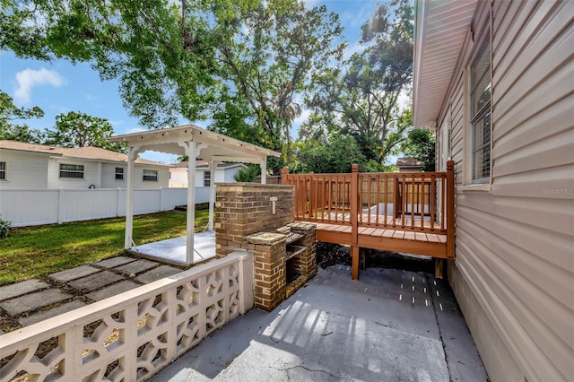 view of patio / terrace featuring a wooden deck and fence