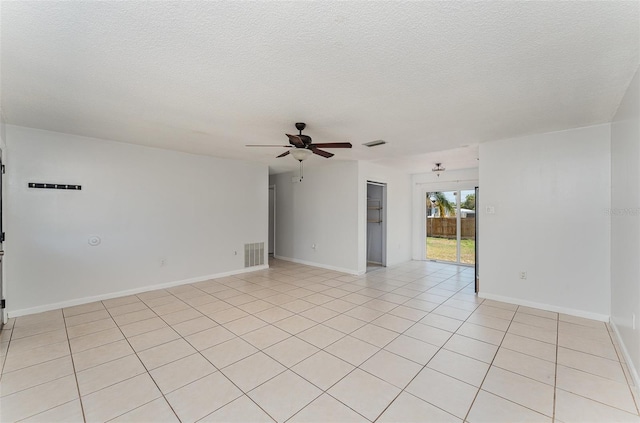 unfurnished room featuring visible vents, light tile patterned floors, ceiling fan, and a textured ceiling