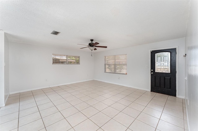 222 Aldo Dr, Babson Park, FL 33827 - foyer entrance featuring ceiling fan, a textured ceiling, light tile patterned floors, and baseboards