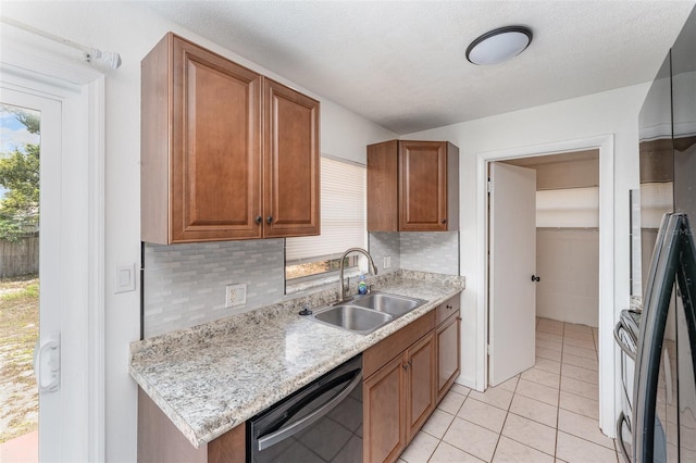 222 Aldo Dr, Babson Park, FL 33827 - kitchen featuring black appliances, a sink, backsplash, light tile patterned floors, and brown cabinets