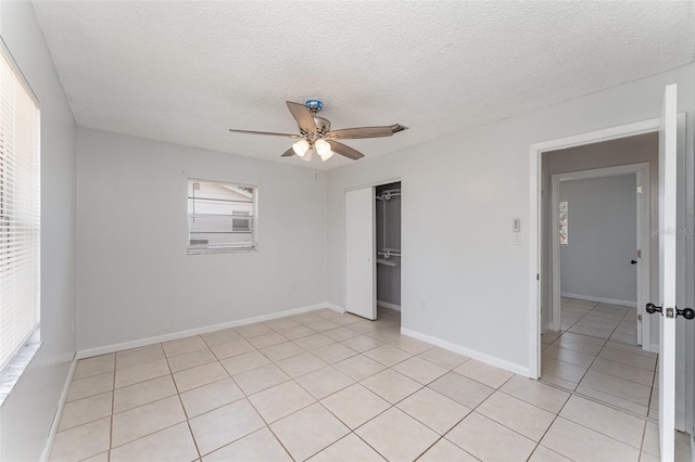 222 Aldo Dr, Babson Park, FL 33827 - unfurnished bedroom with light tile patterned flooring, a textured ceiling, ceiling fan, a closet, and baseboards