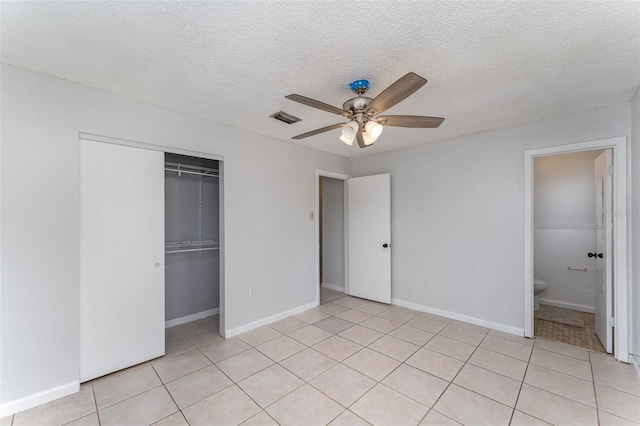 222 Aldo Dr, Babson Park, FL 33827 - unfurnished bedroom with a closet, light tile patterned floors, ceiling fan, baseboards, and a textured ceiling