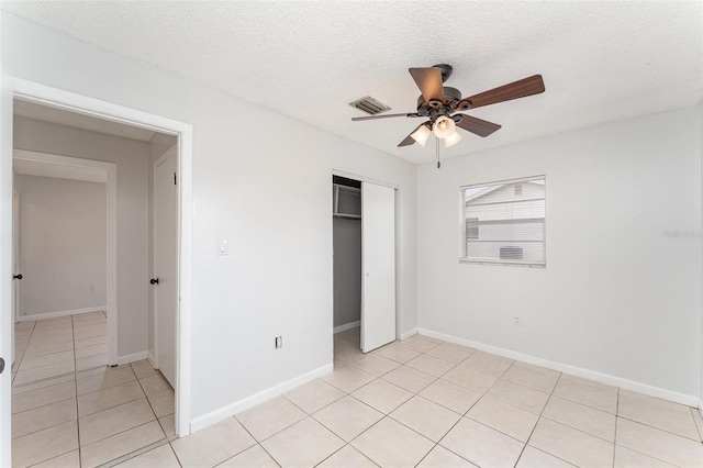 222 Aldo Dr, Babson Park, FL 33827 - unfurnished bedroom featuring light tile patterned floors, a closet, a textured ceiling, a ceiling fan, and baseboards