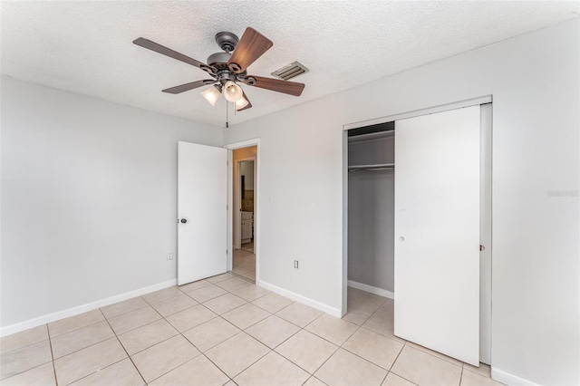 222 Aldo Dr, Babson Park, FL 33827 - unfurnished bedroom featuring light tile patterned floors, a closet, baseboards, and a textured ceiling