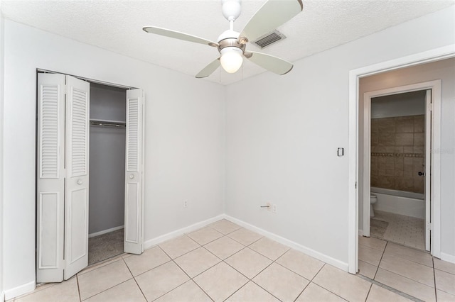 222 Aldo Dr, Babson Park, FL 33827 - unfurnished bedroom featuring light tile patterned floors, a closet, ceiling fan, baseboards, and a textured ceiling