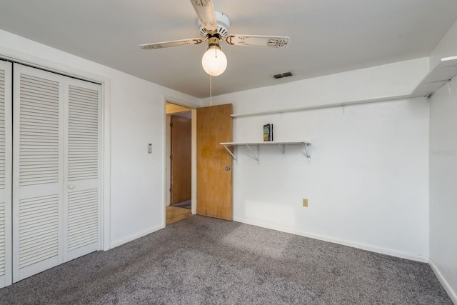 unfurnished bedroom featuring carpet flooring, ceiling fan, baseboards, visible vents, and a closet