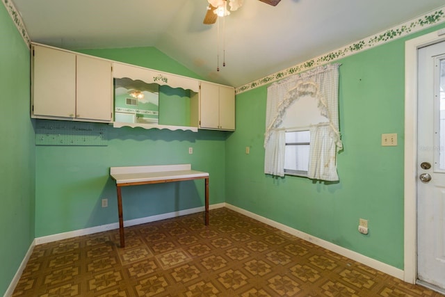 interior space with ceiling fan and baseboards