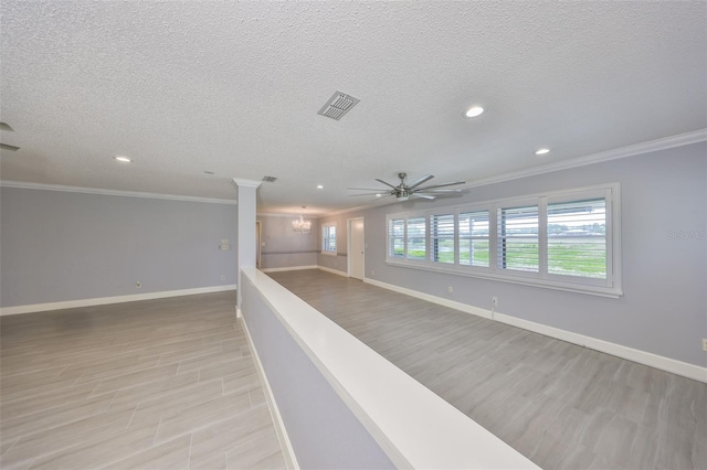 spare room featuring ornamental molding, visible vents, and recessed lighting
