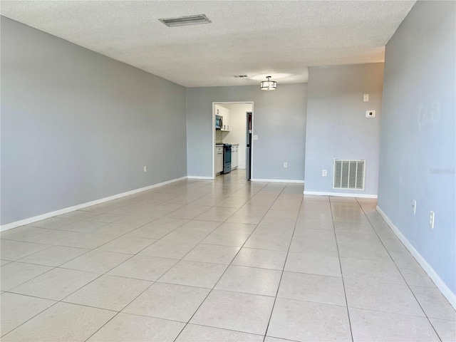 5501 80th St N Unit 509, Saint Petersburg, FL 33709 - spare room with light tile patterned flooring and a textured ceiling