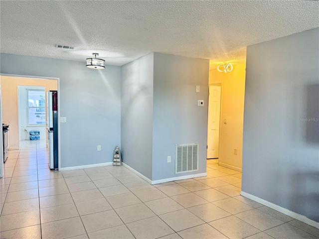 5501 80th St N Unit 509, Saint Petersburg, FL 33709 - spare room featuring a textured ceiling and light tile patterned flooring