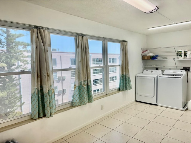 5501 80th St N Unit 509, Saint Petersburg, FL 33709 - laundry room with washing machine and clothes dryer and light tile patterned floors