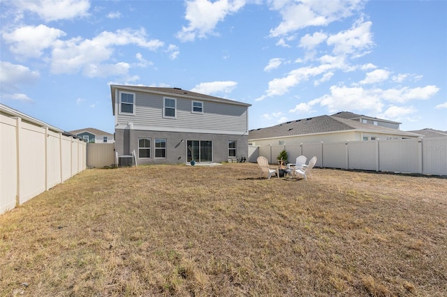 1646 Seth Dr, Winter Haven, FL 33880 - rear view of house featuring central air condition unit, a fenced backyard, and a lawn
