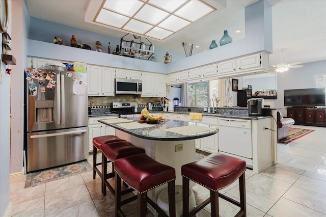 11209 Pocket Brook Dr, Tampa, FL 33635 - kitchen featuring stainless steel appliances, marble finish floor, backsplash, and white cabinetry