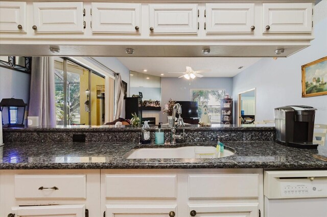 11209 Pocket Brook Dr, Tampa, FL 33635 - kitchen featuring dark stone counters, white cabinets, and a sink
