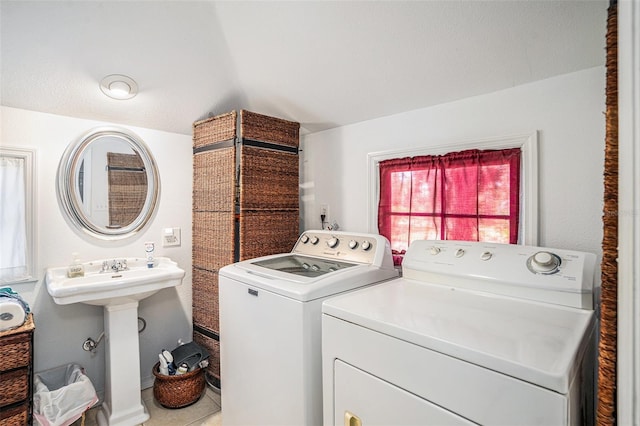 laundry room with independent washer and dryer and tile patterned floors