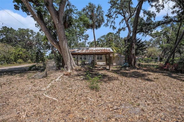 exterior space with fence and a carport
