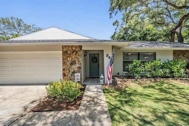 34 Hickory Ln, Safety Harbor, FL 34695 - ranch-style home with concrete driveway, stone siding, and stucco siding