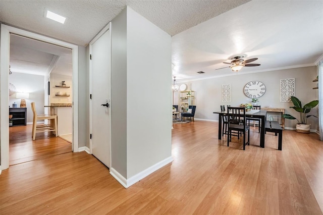 34 Hickory Ln, Safety Harbor, FL 34695 - dining area featuring light wood finished floors, baseboards, ornamental molding, and ceiling fan with notable chandelier