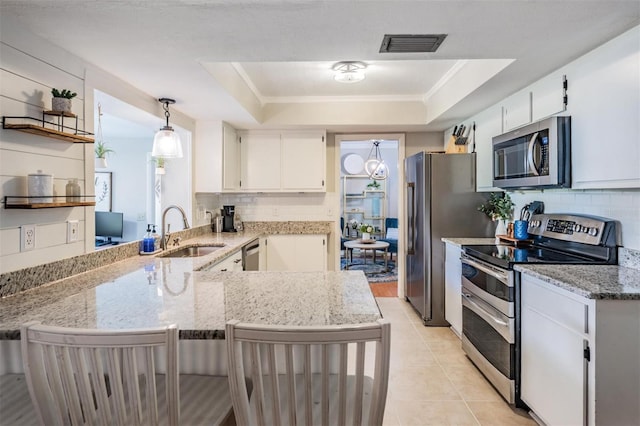 34 Hickory Ln, Safety Harbor, FL 34695 - kitchen with stainless steel appliances, backsplash, a raised ceiling, visible vents, and a sink