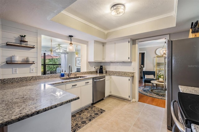 34 Hickory Ln, Safety Harbor, FL 34695 - kitchen featuring ornamental molding, a tray ceiling, a sink, and appliances with stainless steel finishes