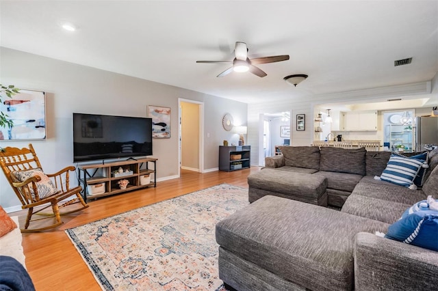 34 Hickory Ln, Safety Harbor, FL 34695 - living area with light wood-style flooring, baseboards, and ceiling fan