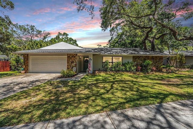 34 Hickory Ln, Safety Harbor, FL 34695 - ranch-style home with driveway, stone siding, a yard, a garage, and stucco siding
