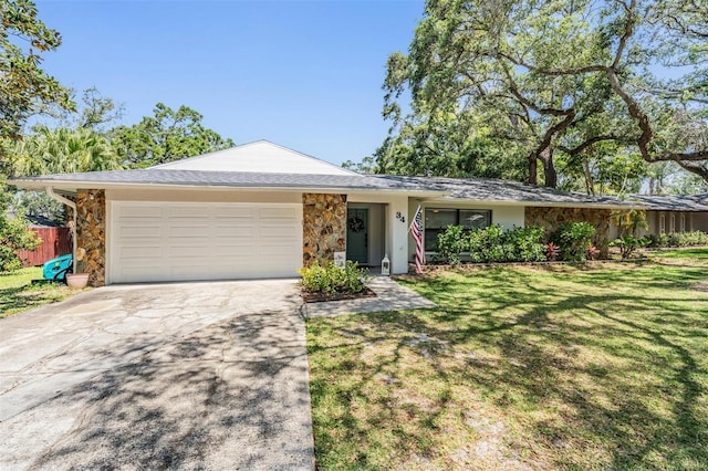 34 Hickory Ln, Safety Harbor, FL 34695 - single story home with concrete driveway, a front lawn, stone siding, and a garage