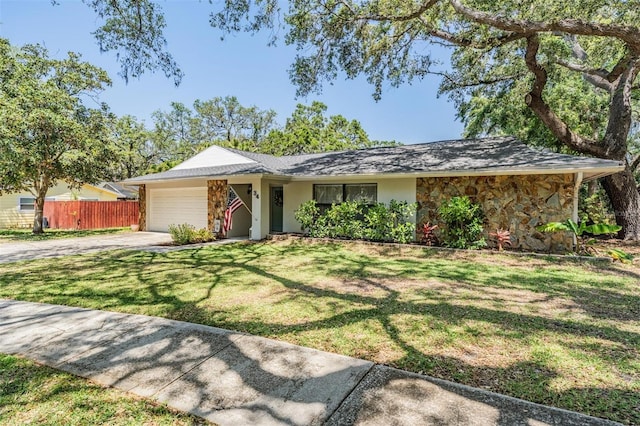 34 Hickory Ln, Safety Harbor, FL 34695 - ranch-style house with stone siding, an attached garage, fence, and concrete driveway