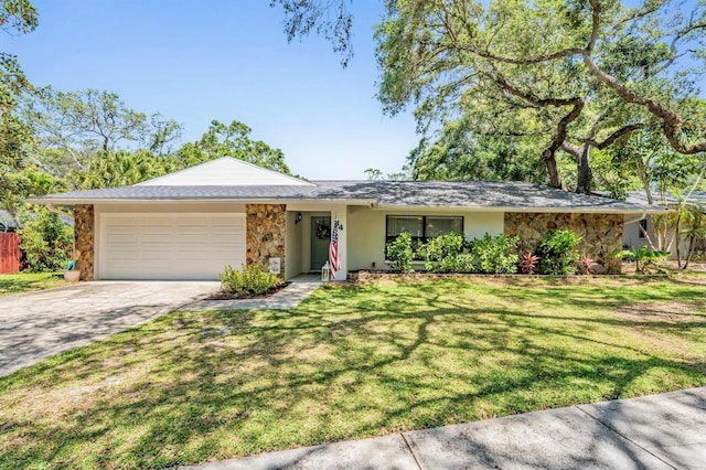 34 Hickory Ln, Safety Harbor, FL 34695 - single story home featuring a front lawn, driveway, stone siding, a garage, and stucco siding