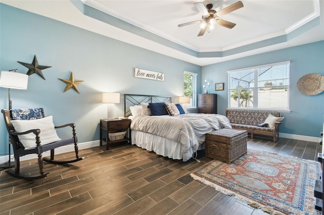 11852 Lake Lucaya Dr, Riverview, FL 33579 - bedroom with ceiling fan, crown molding, dark wood finished floors, baseboards, and a tray ceiling