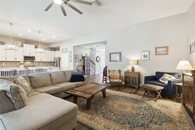 11852 Lake Lucaya Dr, Riverview, FL 33579 - living area featuring visible vents, ceiling fan, dark wood-style floors, and stairway