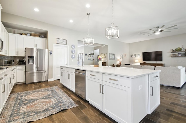 11852 Lake Lucaya Dr, Riverview, FL 33579 - kitchen with light countertops, stainless steel appliances, ceiling fan, and dark wood finished floors