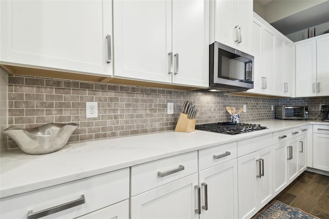 11852 Lake Lucaya Dr, Riverview, FL 33579 - kitchen featuring white cabinetry, appliances with stainless steel finishes, a toaster, and tasteful backsplash
