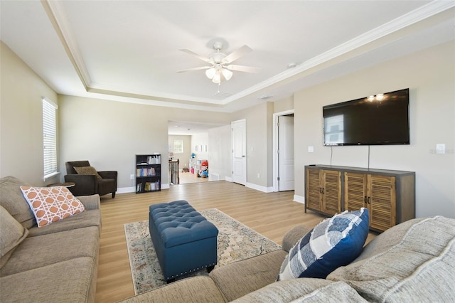 11852 Lake Lucaya Dr, Riverview, FL 33579 - living area with ornamental molding, a ceiling fan, a tray ceiling, and wood finished floors