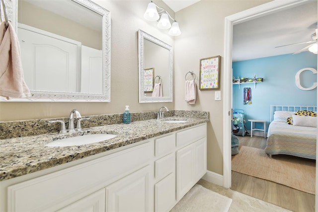 11852 Lake Lucaya Dr, Riverview, FL 33579 - ensuite bathroom with double vanity, a sink, baseboards, and ensuite bathroom