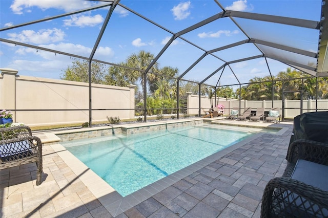 11852 Lake Lucaya Dr, Riverview, FL 33579 - view of swimming pool featuring glass enclosure, a fenced in pool, a fenced backyard, and a patio area