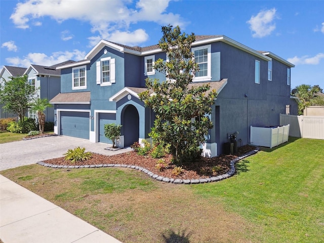 11852 Lake Lucaya Dr, Riverview, FL 33579 - traditional-style home featuring driveway, a front yard, fence, an attached garage, and stucco siding