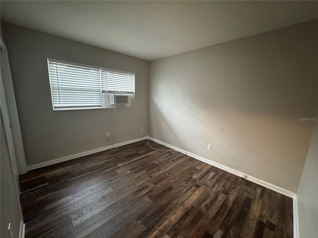 766 Beltrees St, Dunedin, FL 34698 - empty room with dark wood-style floors, baseboards, and cooling unit