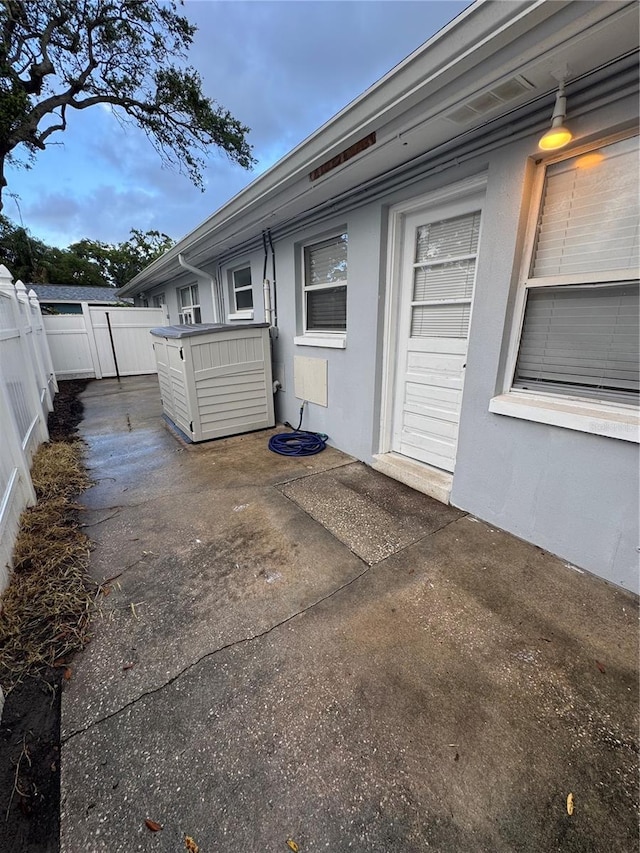 766 Beltrees St, Dunedin, FL 34698 - entrance to property with fence, a patio, and stucco siding