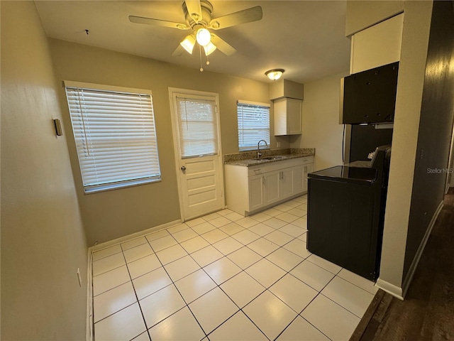 766 Beltrees St, Dunedin, FL 34698 - kitchen with a sink, white cabinetry, a ceiling fan, and baseboards