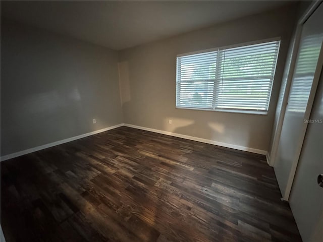 766 Beltrees St, Dunedin, FL 34698 - spare room featuring dark wood-style flooring and baseboards