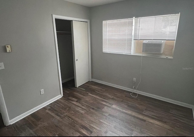 766 Beltrees St, Dunedin, FL 34698 - unfurnished bedroom with a closet, dark wood-type flooring, baseboards, and cooling unit