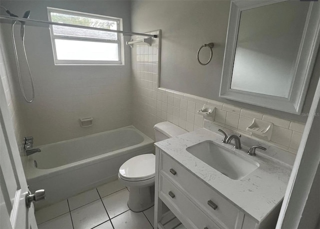 766 Beltrees St, Dunedin, FL 34698 - bathroom featuring toilet, tile walls, shower / bathtub combination, tile patterned flooring, and vanity