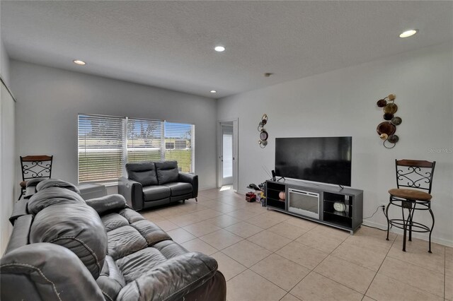 13421 Sydney Rd, Valrico, FL 33594 - living room featuring recessed lighting, a textured ceiling, and light tile patterned floors
