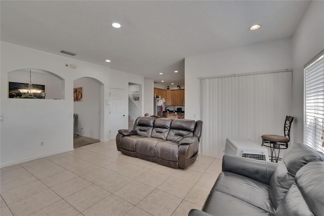 13421 Sydney Rd, Valrico, FL 33594 - living room with arched walkways, a wealth of natural light, recessed lighting, and light tile patterned floors