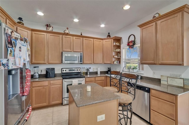 13421 Sydney Rd, Valrico, FL 33594 - kitchen with open shelves, a breakfast bar, a center island, dark stone counters, and appliances with stainless steel finishes