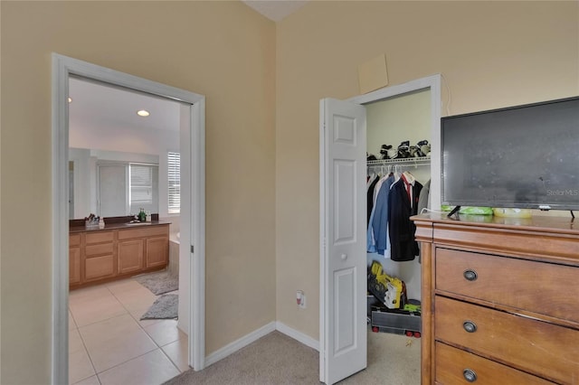 13421 Sydney Rd, Valrico, FL 33594 - bedroom featuring light tile patterned flooring, a closet, baseboards, and ensuite bathroom