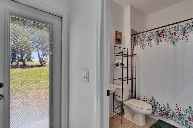 13421 Sydney Rd, Valrico, FL 33594 - full bath with a shower with curtain, tile patterned floors, and toilet