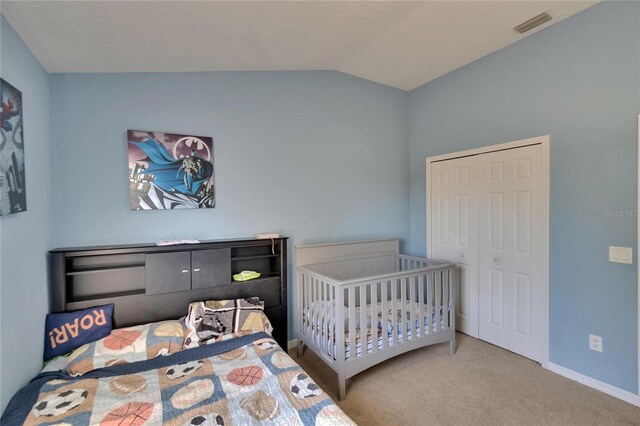 13421 Sydney Rd, Valrico, FL 33594 - carpeted bedroom with lofted ceiling, a closet, visible vents, and baseboards